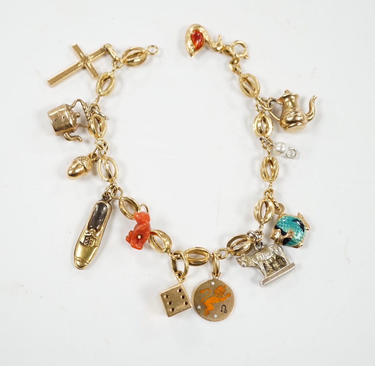 An Italian 750 charm bracelet, hung with eleven assorted charms including 9ct, yellow metal and 800 standard white metal